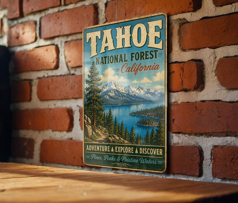 A vintage-style metal sign for Tahoe National Forest in California, featuring a scenic landscape with mountains, pine trees, and a lake.