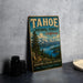 A vintage-style sign for Tahoe National Forest, California, featuring a scenic landscape with mountains, pine trees, and a lake.