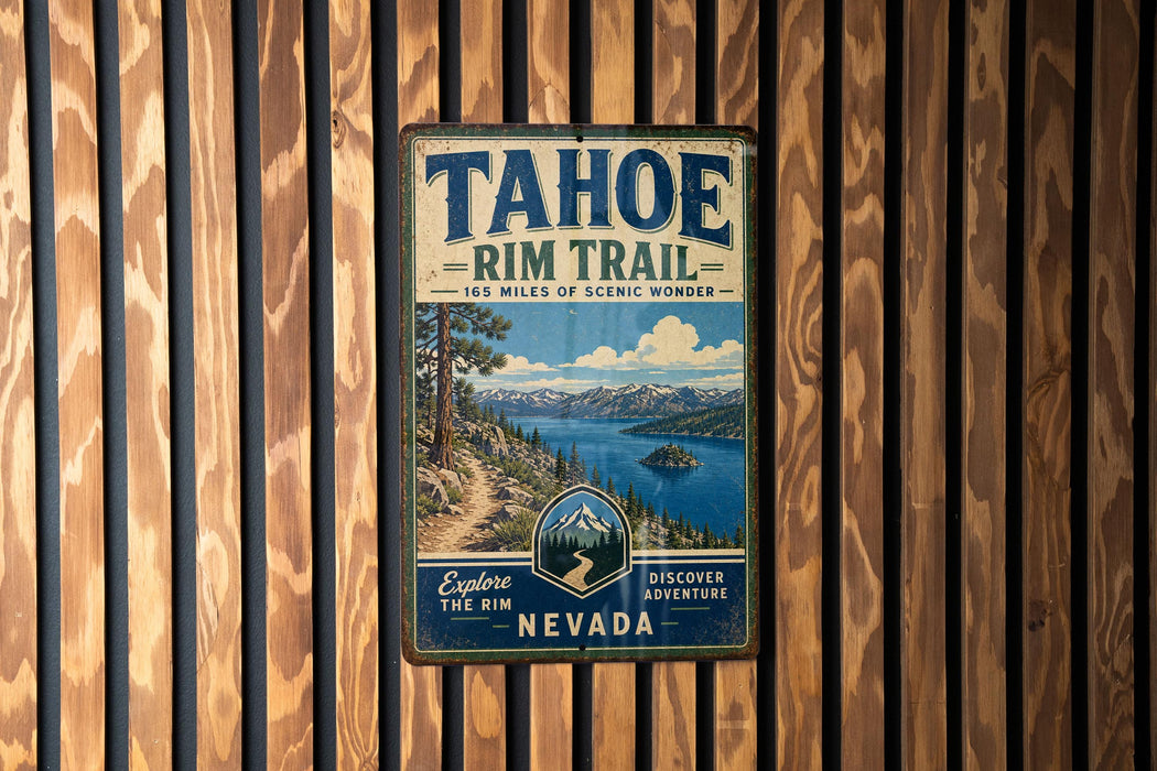 A vintage metal sign for the Tahoe Rim Trail in Nevada, featuring a scenic mountain landscape and a trail.