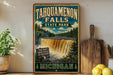 A vintage-style sign for Tahquamenon Falls State Park in Michigan, featuring a waterfall and forest scenery.