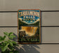 A vintage-style sign for Tahquamenon Falls State Park in Michigan, featuring a waterfall and forest scenery.
