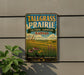 A vintage-style metal sign for Tallgrass Prairie, Kansas, featuring a scenic landscape with tall grass, flowers, and a blue sky with clouds.