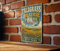 A vintage metal sign for Tallgrass Prairie Preserve in Oklahoma, featuring a scenic landscape with tall grasses and wildflowers.