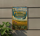 A vintage metal sign for Tallgrass Prairie Preserve in Oklahoma, featuring a scenic landscape with a bird in flight and wildflowers.