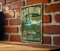 A vintage-style metal sign for the Tar Hollow State Forest in Ohio, featuring a scenic landscape with a waterfall and forest.