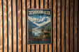 A vintage-style metal sign for Tatshenshini-Alsek Provincial Park in British Columbia, Canada, featuring a scenic mountain landscape with a reindeer in the foreground.