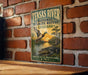 A vintage-style metal sign for the Tensas River National Wildlife Refuge in Louisiana, featuring an illustration of a duck and alligator in a natural setting.
