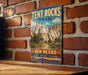 A vintage-style sign for the Tent Rocks Trail in New Mexico, featuring a scenic illustration of the rock formations and desert landscape.