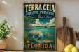 A vintage-style metal sign for the Terra Ceia Aquatic Preserve in Florida, featuring an illustration of a manatee and sea turtle swimming in the ocean.