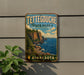 A vintage-style metal sign for Tettegouche State Park in Minnesota, featuring a scenic landscape with a cliff overlooking the water.