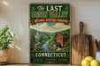 A vintage-style sign for "The Last Green Valley National Heritage Corridor" in Connecticut, featuring a scenic image of a river and a red brick building.
