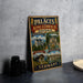 A vintage metal sign displaying the palaces of King Ludwig II in Bavaria, Germany, with images of the palace, gardens, and other landmarks.