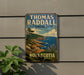 A vintage-style metal sign for Thomas Radcliffe Provincial Park in Nova Scotia, featuring a scenic landscape with a rocky coastline, pine trees, and a blue sky with clouds.