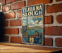 A vintage metal sign for the Tijuanan Slough National Wildlife Refuge in California, featuring illustrations of various wildlife species.