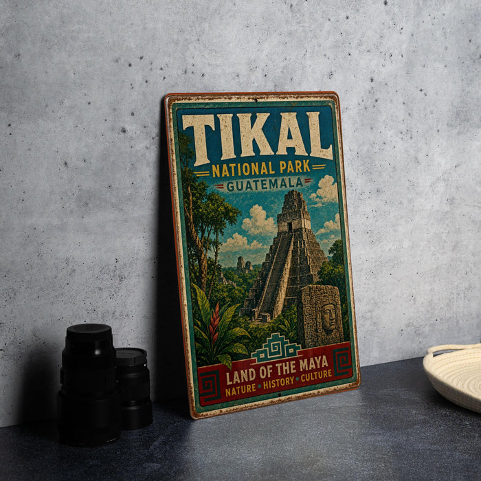 A vintage-style metal sign for the Tikal National Park in Guatemala, featuring an illustration of the Mayan ruins of Tikal.