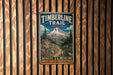 A vintage-style metal sign for the Timberline Trail in Oregon, featuring a mountain landscape and trail information.