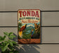 A vintage-style sign for the Tonda Wildlife Management Area in Papua New Guinea, featuring colorful illustrations of tropical birds and animals.
