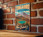 A vintage-style metal sign for Tongarro National Park in New Zealand, featuring a scenic mountain landscape with a lake and a waterfall.