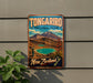 A vintage-style metal sign for Tongarif National Park in New Zealand, featuring a scenic landscape with mountains, a lake, and a plant.