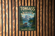 A vintage-style metal sign for Tongass National Forest in Alaska, featuring a scenic landscape with a bear, mountains, and a river.