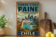 A vintage-style sign for the Torres del Paine Biosphere Reserve in Chile, featuring a llama and a mountainous landscape.