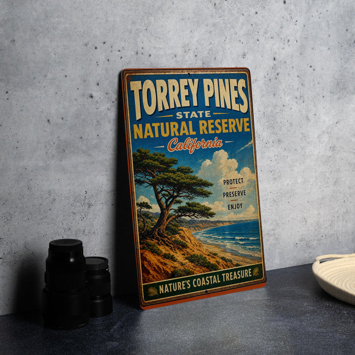 A vintage-style metal sign for Torrey Pines State Natural Reserve in California, featuring a scenic landscape with a pine tree and ocean.