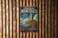 A vintage metal sign advertising the Tower of Hercules, a historic lighthouse located in La Coruna, Spain.