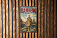 A vintage metal sign for the town of Bamberg, Germany, featuring an illustration of a historic building and a river.