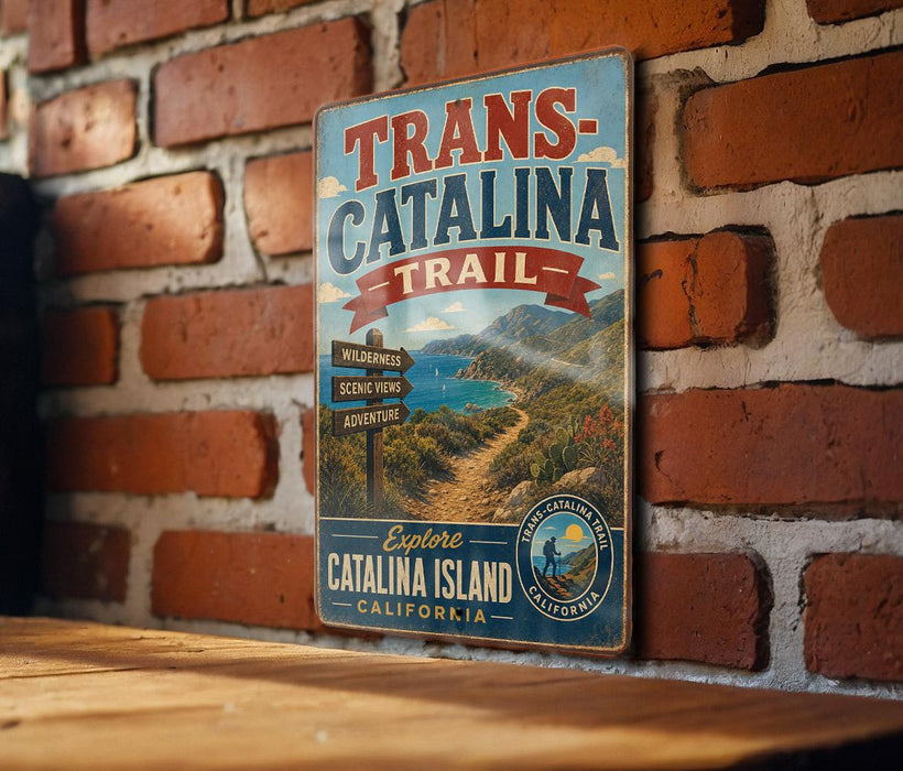 A vintage metal sign for the Trans-Catalina Trail in Catalina Island, California, featuring a scenic mountain landscape and directional signs.