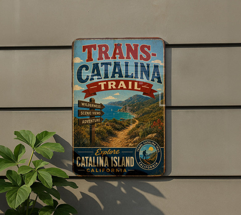 A vintage metal sign for the Trans-Catalina Trail in California, featuring a scenic landscape with mountains, a winding path, and a signpost.