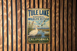 A vintage metal sign for Tule Lake National Wildlife Refuge in California, featuring a white goose and a serene landscape.