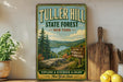 A vintage-style metal sign for Tulter Hill State Forest in New York, featuring a scenic landscape with a lake and mountains.