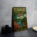 A vintage metal sign for Tuskegee National Forest in Alabama, featuring a scenic landscape with a deer and a river.