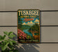 A vintage-style metal sign for Tuskegee National Forest in Alabama, featuring a scenic landscape with a deer and a river.