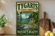 A vintage-style sign for Tygarts State Forest in Kentucky, featuring a scenic image of a forest and a river.