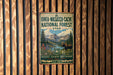 A vintage metal sign for the Uinta-Wasatch-Cache National Forest in Utah, featuring a mountain landscape and a moose.