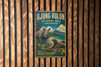 A vintage-style metal sign for the Ujung Kulon National Park in Indonesia, featuring an illustration of a rhino and a lizard in a lush, tropical setting.