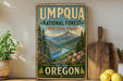 a vintage-style sign for the Umpqua National Forest in Oregon, with a scenic mountain landscape and a river in the background.