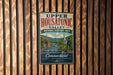 A vintage metal sign for Upper Housatonic Valley, New Hampshire's National Heritage Area, hanging on a wooden wall.