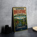 A vintage-style sign for the Upper Housatonic Valley National Heritage Area in Connecticut, featuring a scenic illustration of a river and buildings.