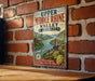 A vintage-style metal sign with the text "Upper Middle Rhine Valley Germany" displayed on a brick wall.