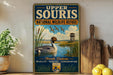 A vintage-style metal sign for Upper Souris National Wildlife Refuge in North Dakota, featuring an illustration of ducks swimming in a lake surrounded by tall grasses and a birdhouse.