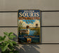 A vintage-style metal sign for Upper Souris National Wildlife Refuge in North Dakota, featuring a duck and a water tower in the background.