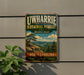 A vintage-style metal sign for Uwharrie National Forest, featuring a scenic landscape with pine trees and mountains.