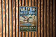 A vintage-style metal sign for the Valentine National Wildlife Refuge in Nebraska, featuring a duck in flight and a scenic landscape.