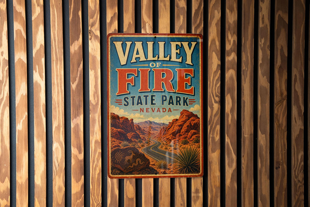 A vintage metal sign for Valley of Fire State Park in Nevada, featuring a desert landscape with mountains and a winding road.