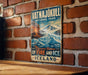 A vintage-style metal sign for Vatnajokull National Park, featuring a mountain landscape with a volcano and ice formations.