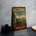 A vintage metal sign for Vickburg National Military Park, featuring a cannon and a river, is displayed on a gray countertop.