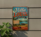 A vintage-style metal sign for Villa Louis, Wisconsin, mounted on a wall.
