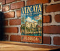 A vintage metal sign for the Vizcaya Museum and Gardens in Florida, featuring an illustration of the landmark and the text "A Timeless Escape" and "FLORIDA".